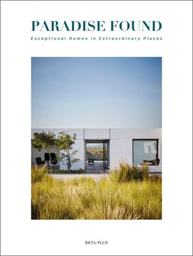 Modern building with flat roof surrounded by long green grass, on white cover of 'Paradise Found, Exceptional Homes in Extraordinary Places', by Beta-Plus.