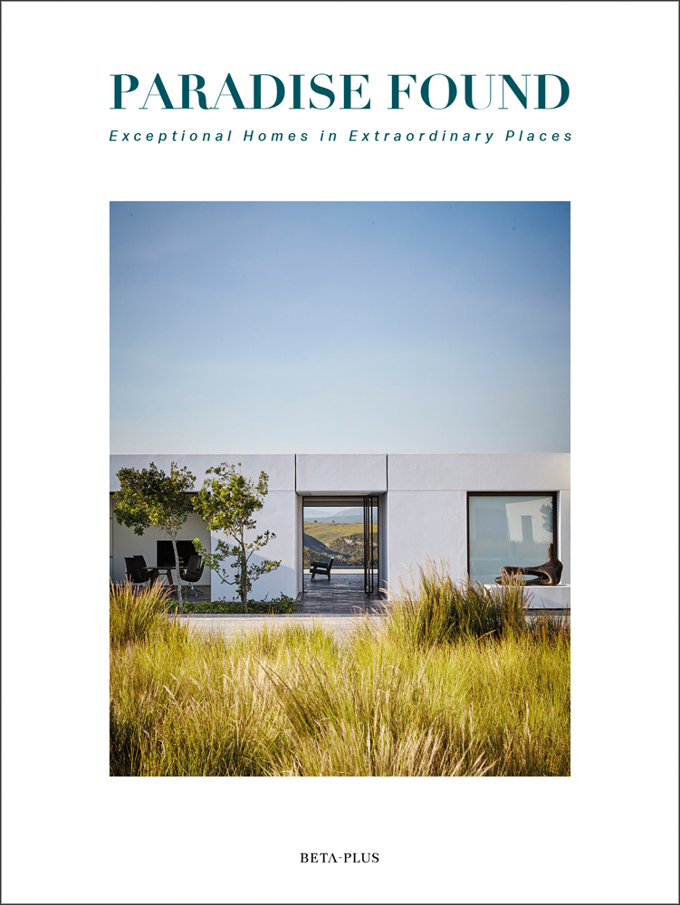 Modern building with flat roof surrounded by long green grass, on white cover of 'Paradise Found, Exceptional Homes in Extraordinary Places', by Beta-Plus.