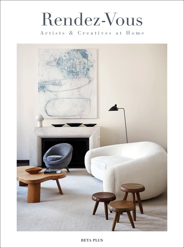 White curved sofa, 3 wood stools, cream fire surround, Rendez-Vous Artists & Creatives at Home in grey font on top white border
