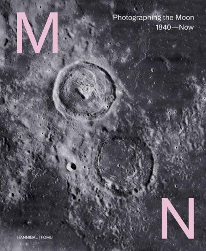 Close up of Moon's grey surface, 2 large craters, MOON diagonally in pink, with craters for letter O.