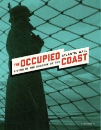 Solider armed with rifle, staring out to sea through wired fence, on cover of 'The Occupied Coast, Living in the Shadow of the Atlantic Wall', by Hannibal Books.