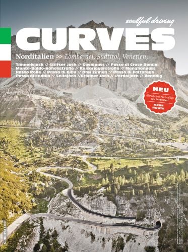 Snow topped mountainous landscape with winding road pass below, on cover of 'Curves: Northern Italy, Lombardy, South Tyrol, Veneto', by Delius Klasing.