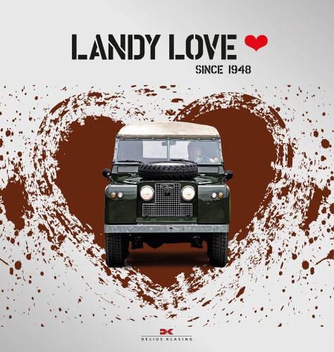 Front of old green Land Rover with driver, on white cover with paint brushed red heart, Landy Love in black stencilled font above, red heart to right