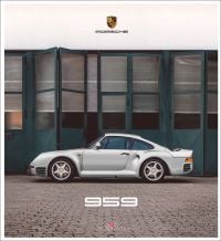 Silver Porsche 959 in front of large folding green doors, on cover of 'Porsche 959', by Delius Klasing.