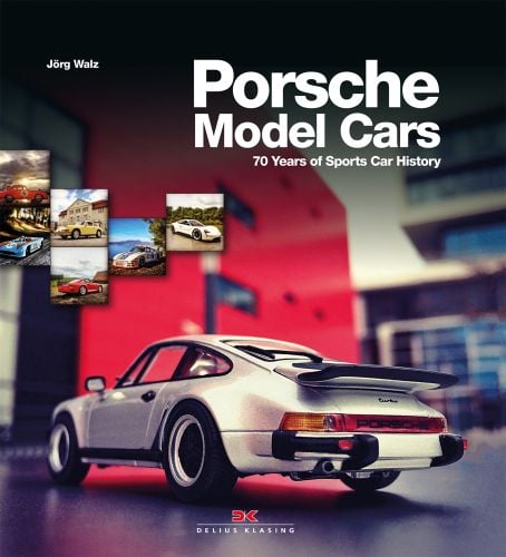 Rear-view of white Porsche 911 miniature model, on grey table, Porsche Model Cars in white font above