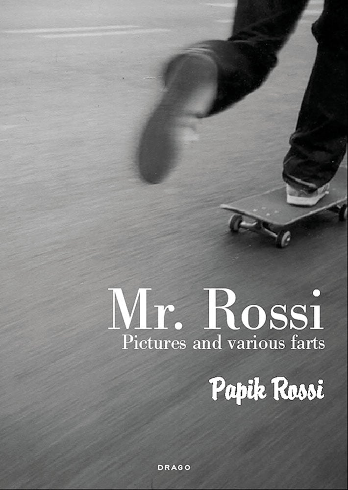 Feet of skateboarder skating away from camera, 'Mr Rossi, Pictures and Various Farts', in white font below, by Drago International Entertainment.