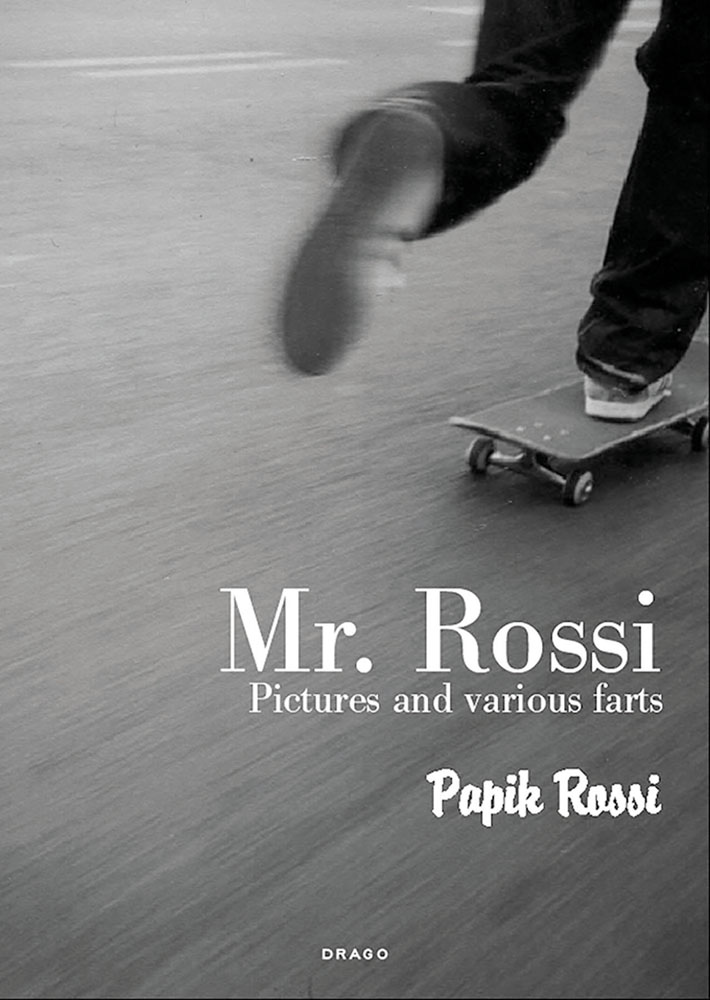 Feet of skateboarder skating away from camera, on cover of 'Mr Rossi, Pictures and Various Farts', by Drago International Entertainment.