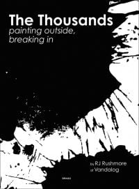 Black splattered paint on white cover of 'The Thousands, Painting Outside, Breaking In', by Drago.