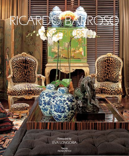 Interior living room with two leopard print chairs, Japanese screen, orchid on table, on cover of 'Ricardo Barroso Interiors', by Ediciones El Viso.