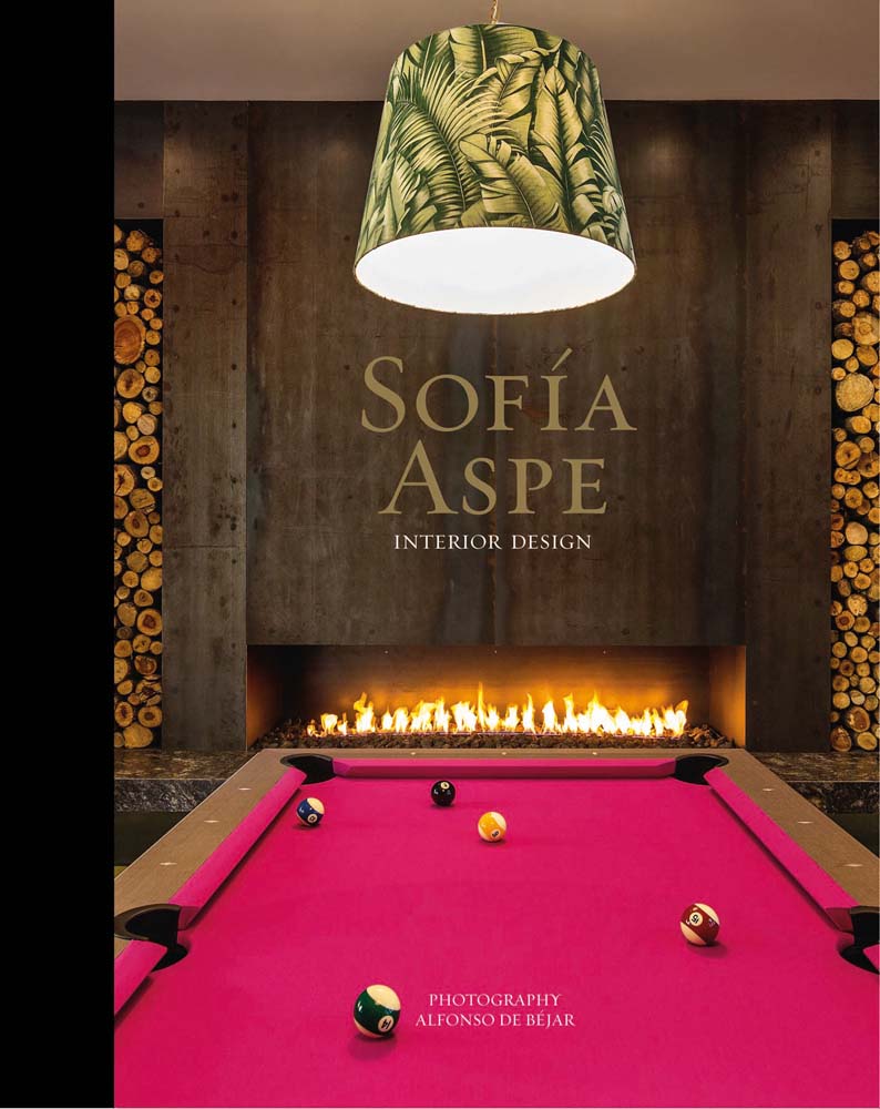 Pink felt pool table with lit fireplace in background, SOFIA ASPE Interior Design in gold and white font above