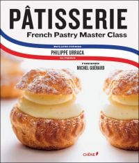 Profiteroles filled with cream on cover of 'Patisserie: French Pastry Master Class', by Editions du Chene.