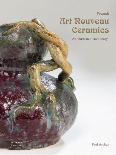 Art Nouveau style ceramic pot in dark plum red, gold branches forming handle, on cover of 'French Art Nouveau Ceramics, An Illustrated Dictionary', by Editions Norma.