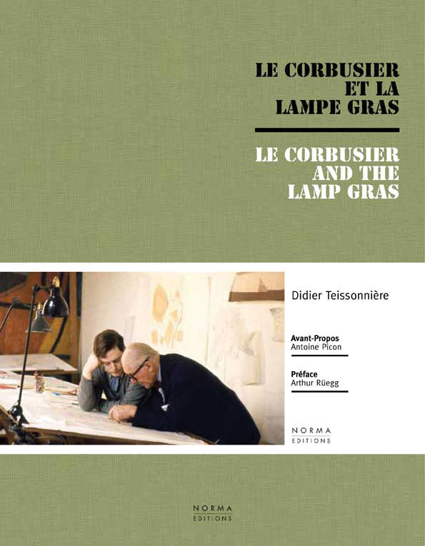 Two men sitting at drawing desk in design studio, on cover of 'Le Corbusier and the Gras Lamp', by Editions Norma.