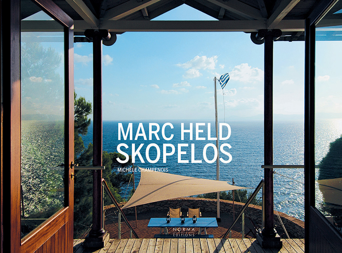 Residence with doors opening out to a sunny seascape, pole with flag of Greece flying, on landscape cover of 'Marc Held - Skopelos', by Editions Norma.