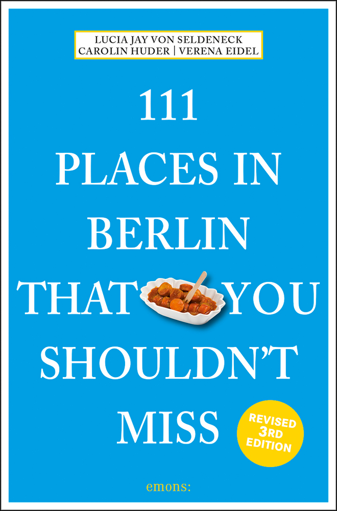 Dish of chopped Bratwurst sausages near centre of bright blue cover of '111 Places in Berlin That You Shouldn't Miss', by Emons Verlag.