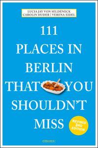 Dish of chopped Bratwurst sausages near center of bright blue cover of '111 Places in Berlin That You Shouldn't Miss', by Emons Verlag.