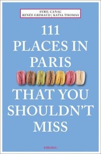 Seven colored macarons to center of sky blue cover of '111 Places in Paris That You Shouldn't Miss', by Emons Verlag.