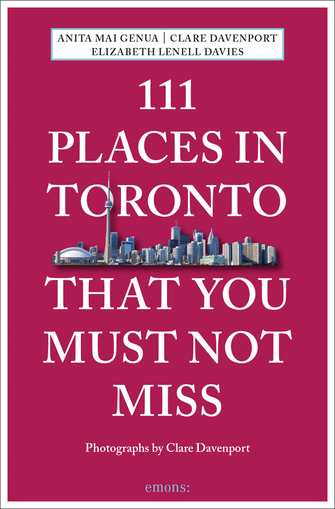 City skyline near centre of burgundy cover of '111 Places in Toronto That You Must Not Miss', by Emons Verlag.