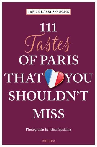 Heart cookie with French flag fondant to top, near centre of dark purple cover of '111 Tastes of Paris That You Shouldn't Miss', by Emons Verlag.