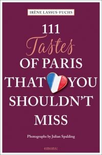 Heart cookie with French flag fondant to top, near center of dark purple cover of '111 Tastes of Paris That You Shouldn't Miss', by Emons Verlag.