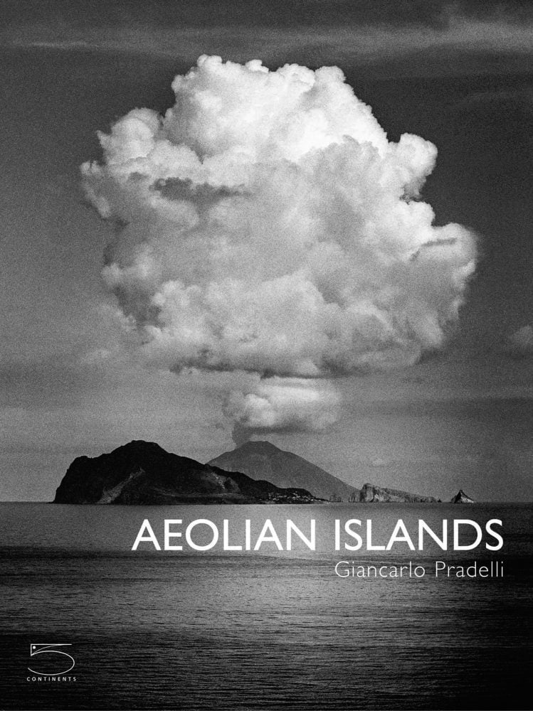 Book cover of The Aeolian Islands, featuring a black and white shot of erupting volcano with white clouds above. Published by 5 Continents Editions.