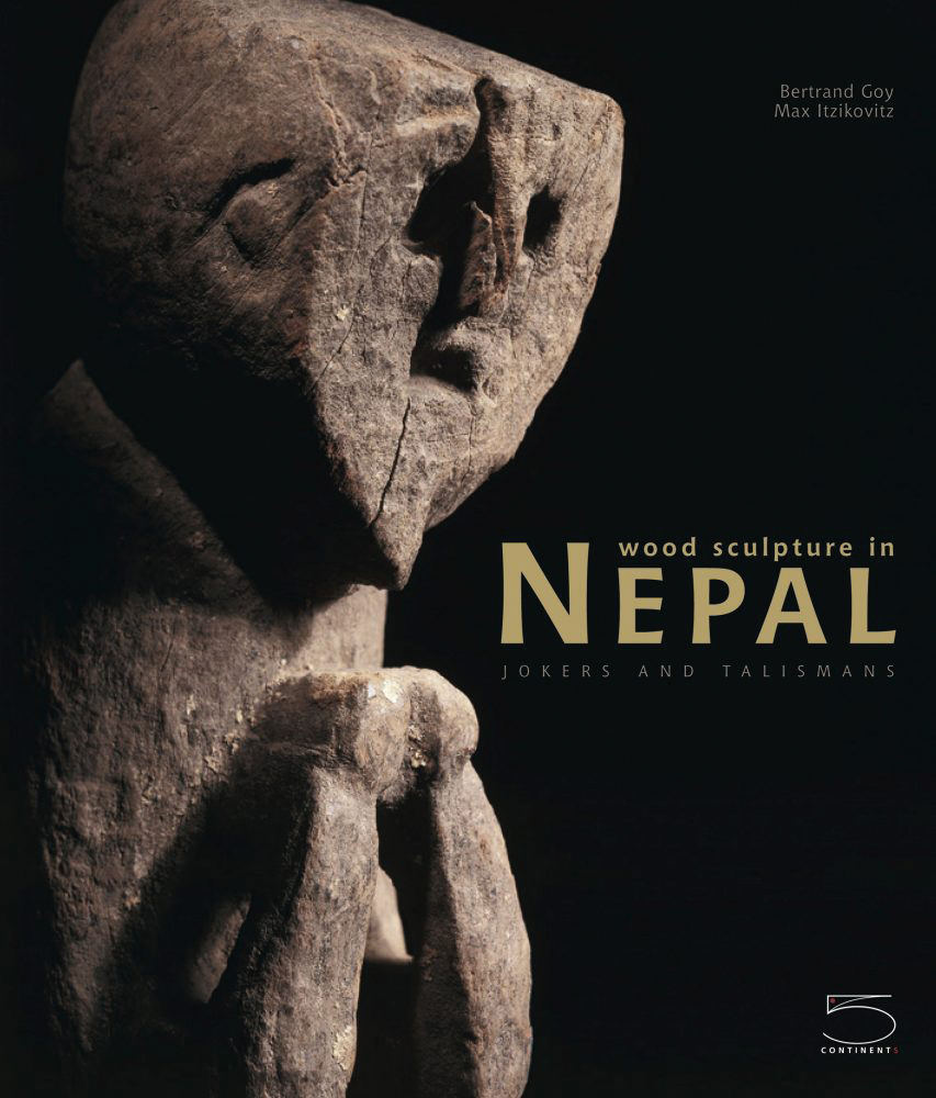 Carved wood figure, black cover, wood sculpture in NEPAL in gold font to lower right.