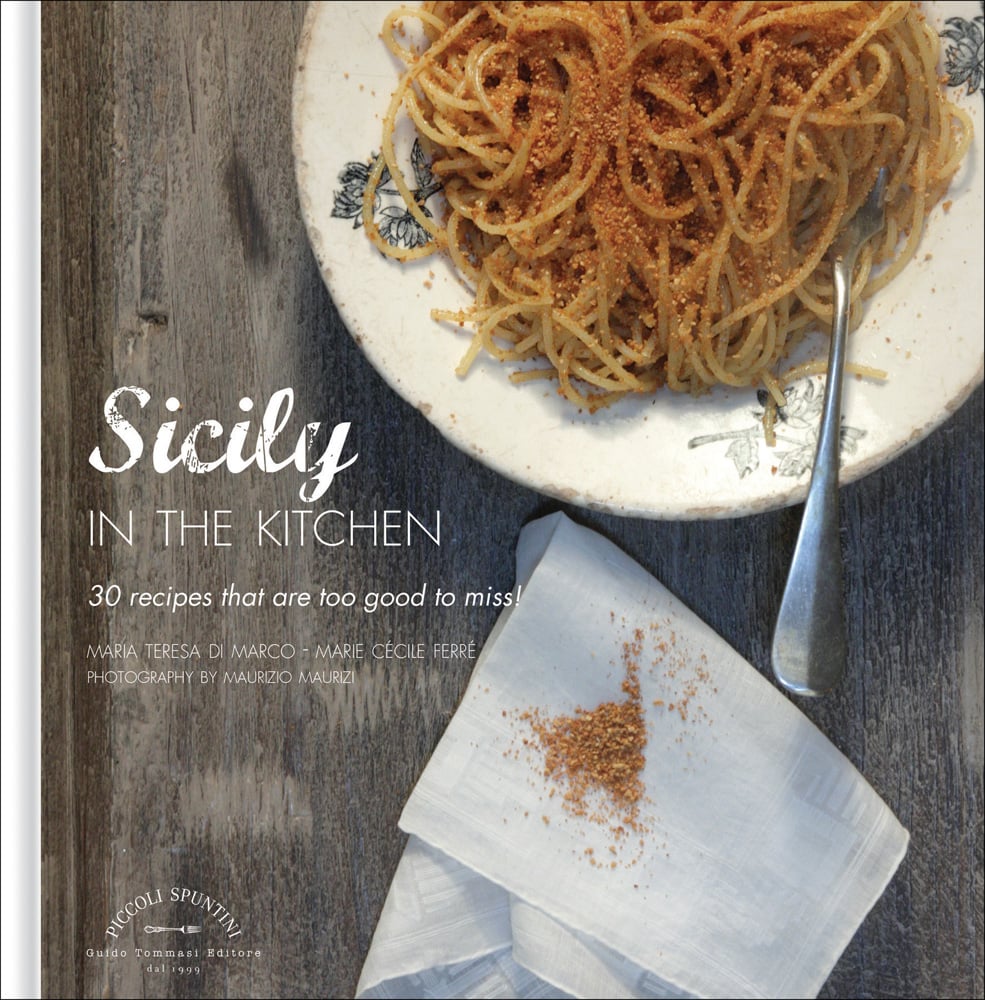 Bowl of spaghetti on cover of 'Sicily in the Kitchen: 30 Recipes That Are Too Good To Miss! by Guido Tommasi Editore.