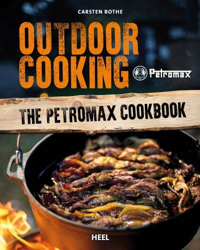 Iron pot of food cooking over fire, on cover of 'Outdoor Cooking, The Petromax Cookbook', by HEEL.