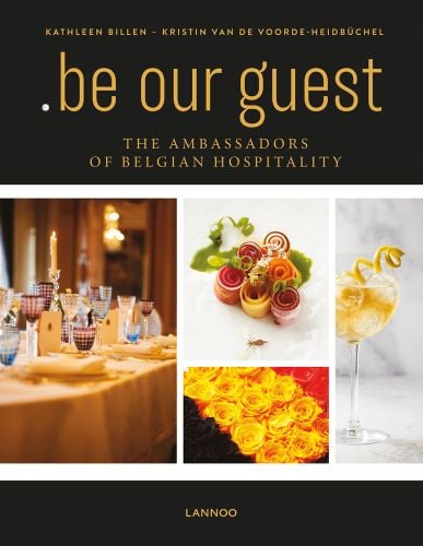 Dining table with glasses, lit candle, canapes, on black cover of '.be Our Guest, The Ambassadors of Belgian Hospitality', by Lannoo Publishers.