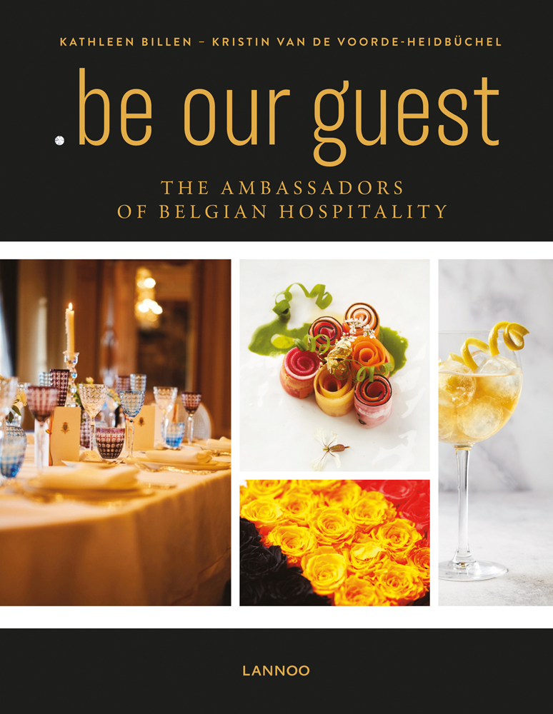 Dining table with glasses, lit candle, canapes, on black cover of '.be Our Guest, The Ambassadors of Belgian Hospitality', by Lannoo Publishers.