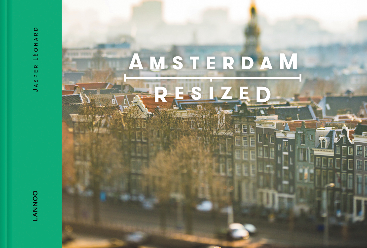 Special tilt-shift lens creating a miniature model effect of a residential street lined with trees, on cover of ' Amsterdam Resized', by Lannoo Publishers.