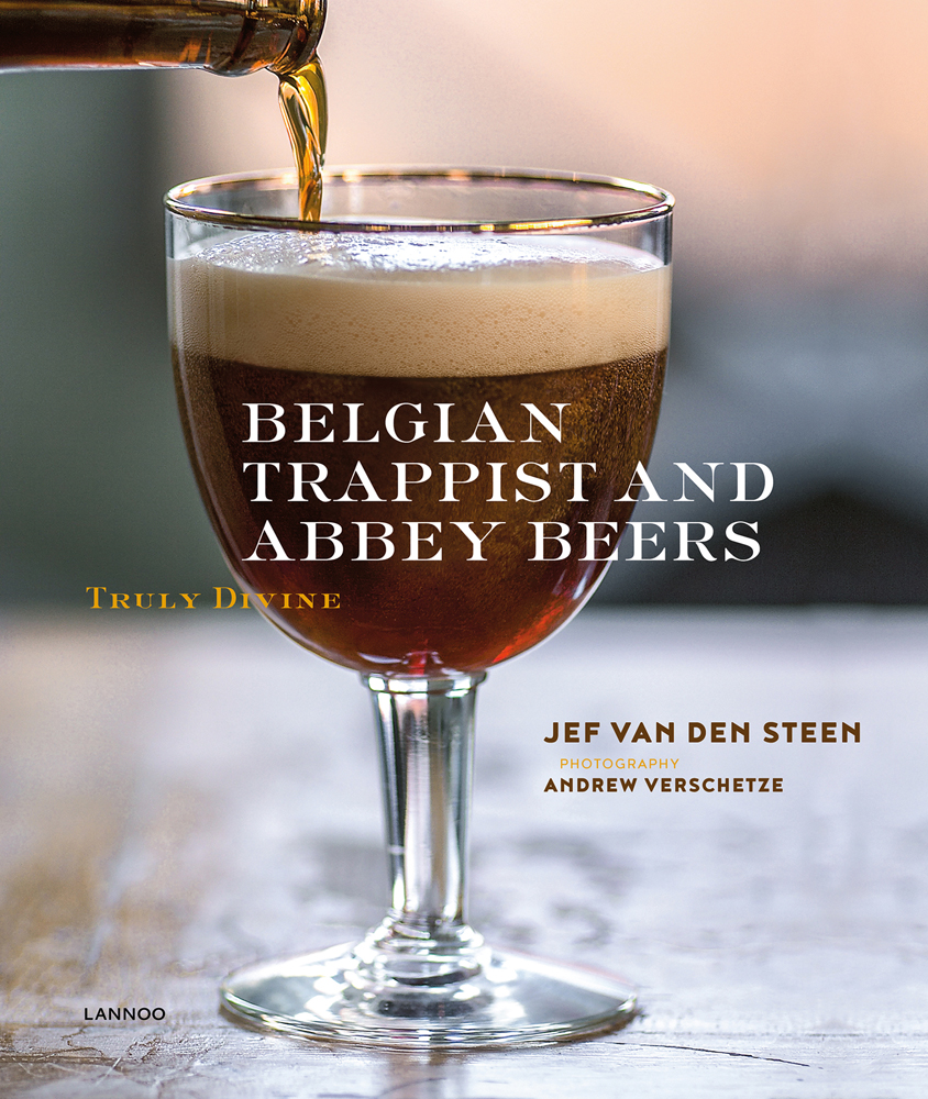 Bottle of dark ale being poured into glass, on cover of 'Belgian Trappist and Abbey Beers, Truly Divine', by Lannoo Publishers.