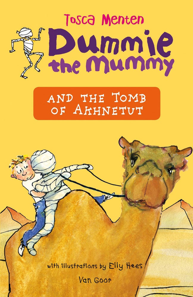Golden camel with small child and Egyptian mummy on back, in desert with pyramids, on cover of 'Dummie the Mummy and the Tomb of Akhnetut', by Lannoo Publishers.