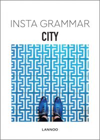 Aerial shot of pointed blue shoes on blue and white tiled floor, on white cover of 'Insta Grammar: City', by Lannoo Publishers.