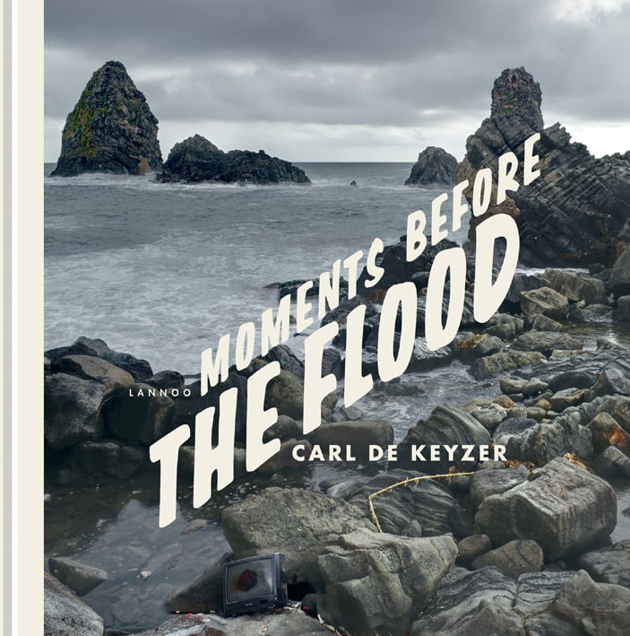 Rocky coastline with grey sea and clouds, on cover of 'Moments Before the Flood', by Lannoo Publishers.