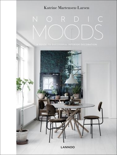 Minimalist dining interior, table and chairs, low light fixing, white walls, NORDIC MOODS in white font above.