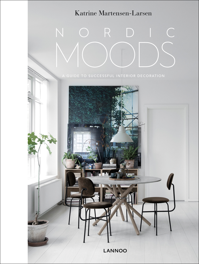 Minimalist dining interior, table and chairs, low light fixing, white walls, on cover of 'Nordic Moods', by Lannoo Publishers.