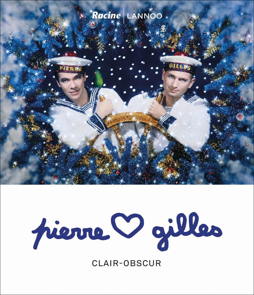 Photograph painted on of 'The Two Sailors', two male sailors holding onto ship's wheel, on cover of 'Pierre and Gilles, Clair-obscur', by Lannoo Publishers.
