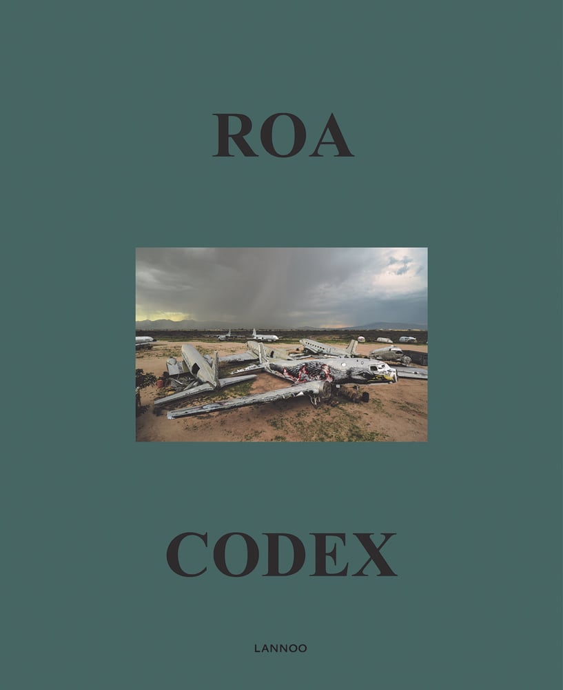 Bald Eagle painted on side of abandoned airplane, on green cover of 'ROA Codex', by Lannoo Publishers.