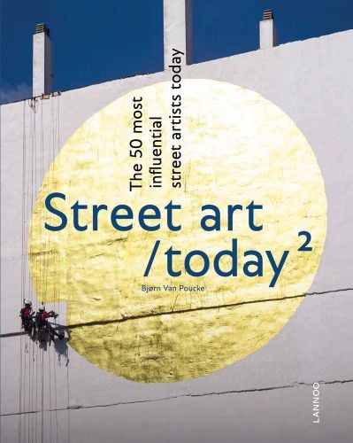 2 artists abseiling down building painting a large gold circle on white concrete, Street art / today 2 in dark blue font to centre.