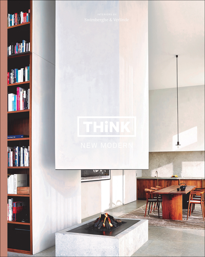Figure walking away through interior corridor with looming light grey walls and Andrew Martin Interior Design Review in black font above