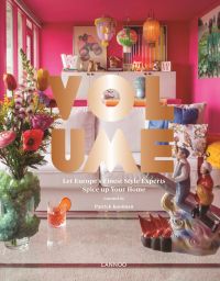 Interior living space with pink walls, oriental lights, quirky figurine and vase, on cover of 'Volume, Let Europe's Finest Style Experts Spice up Your Home', by Lannoo Publishers.