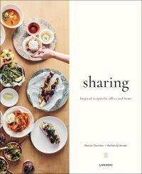 Aerial shot of plated food, hand placing bowl of food down, on cover of 'Sharing Inspired recipes for Office and Home', by Lannoo Publishers.