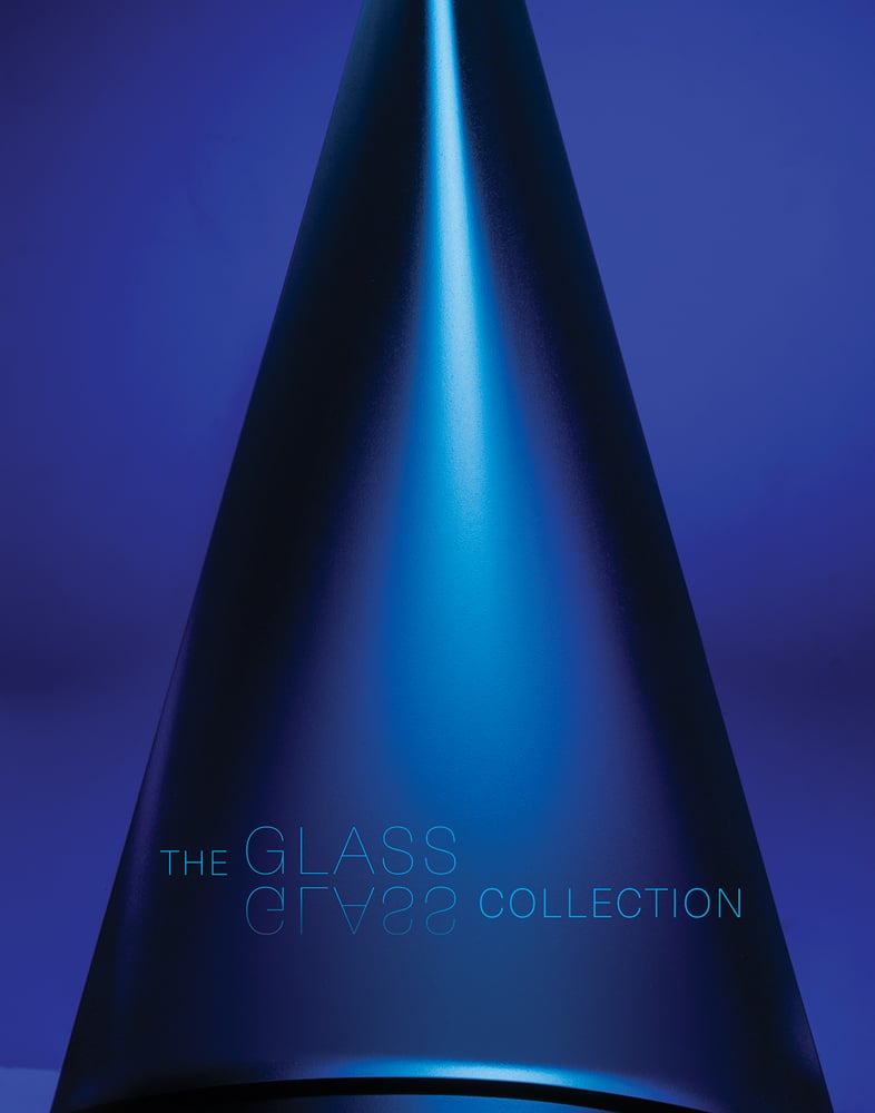 Electric blue cover with cone shaped glass piece, The Glass Glass Collection in light blue font to lower edge