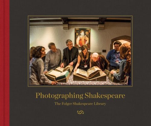 Group of people looking through large library books, on grey cover, Photographing Shakespeare in gold font below