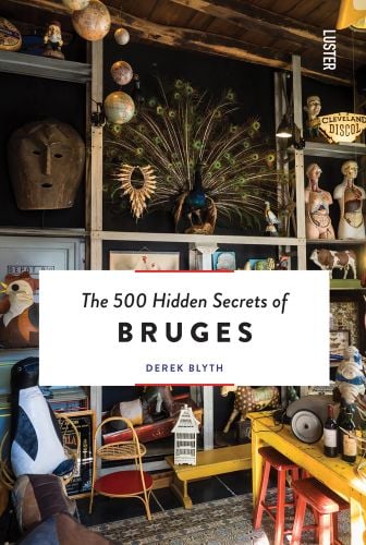 Antique shop interior, peacock on shelf, mask on wall, The 500 Hidden Secrets of Bruges in black font on white centre banner.