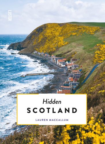 Aberdeenshire coastline with yellow gorse, houses near sea, Hidden SCOTLAND in black font on bottom white banner.
