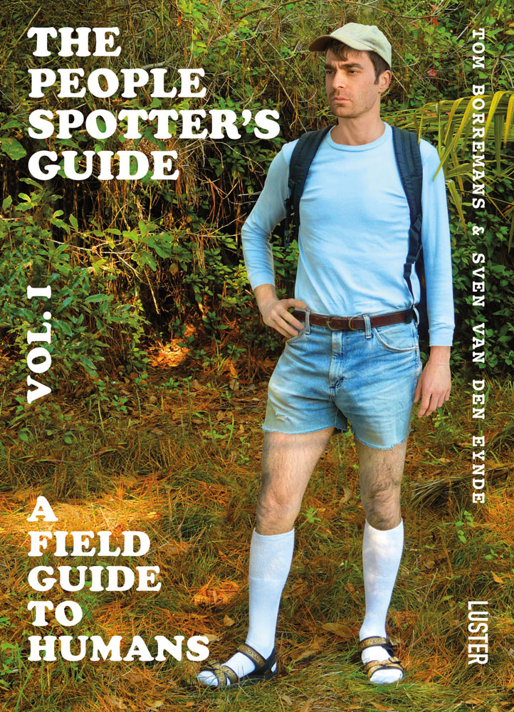 Man in blue top, denim shorts, white knee socks, baseball cap, in forest landscape, The People Spotter's Guide Vol. 1 in white font to top left