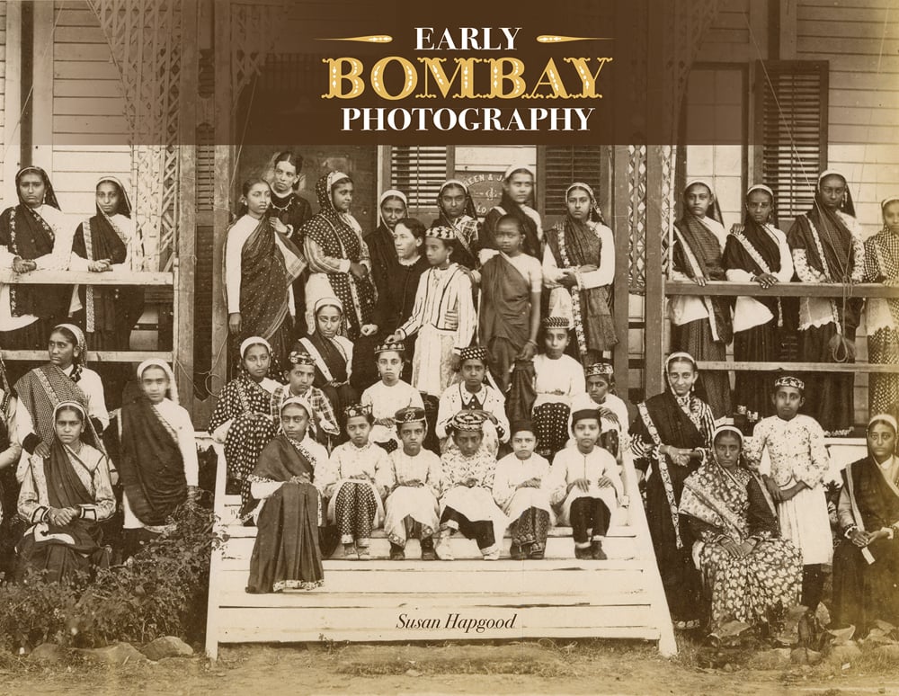 Book cover of Early Bombay Photography, with a sepia-toned image of a group of figures standing at the front steps of a building. Published by Mapin Publishing.