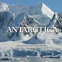 Book cover of The Continent of Antarctica, with snow covered mountains, ocean below. Published by Papadakis.